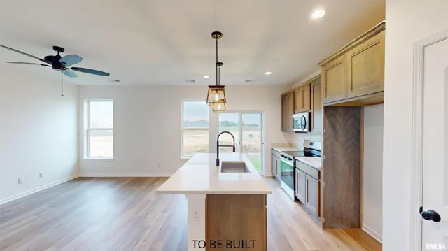 a view of a kitchen with a sink wooden floor and a window