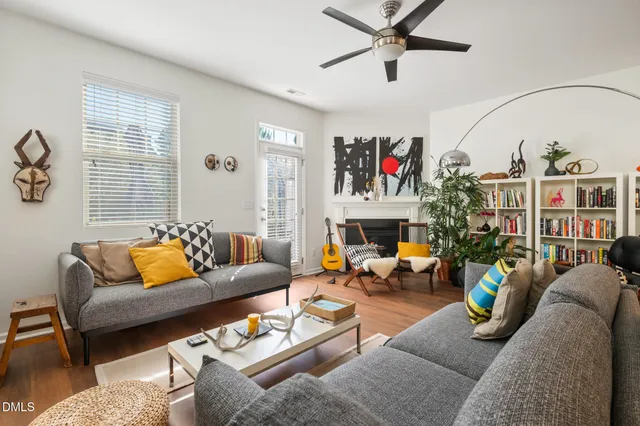 a living room with furniture and a book shelf