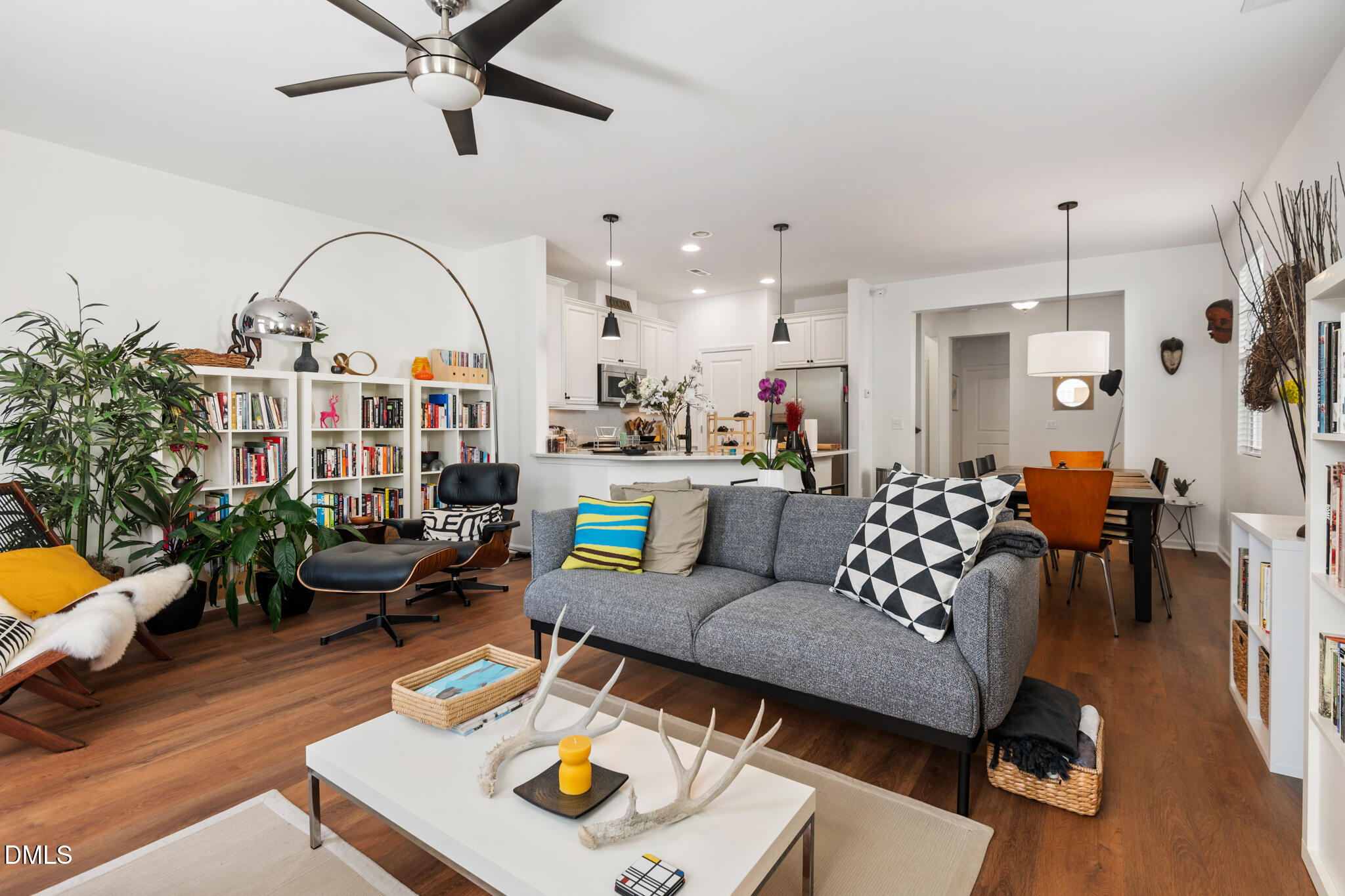 545 Libson Street Durham, NC 27703 - Photo 18 of 53 a living room with furniture kitchen view and a chandelier