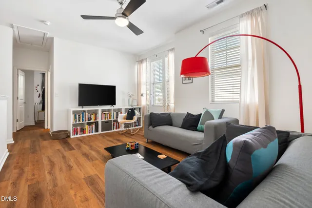 a living room with furniture and wooden floor