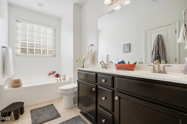 a white toilet sitting next to a bathroom sink