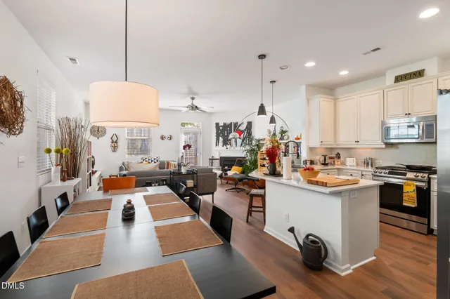 a kitchen with kitchen island a sink stove and refrigerator