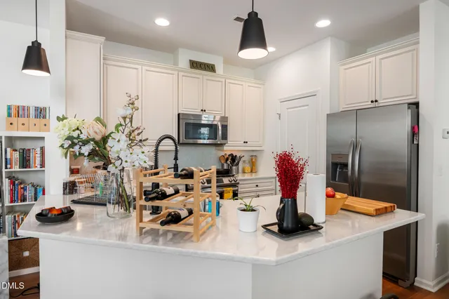 a kitchen with sink refrigerator and cabinets
