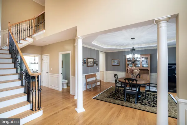 a living room with furniture a fireplace and a floor to ceiling window