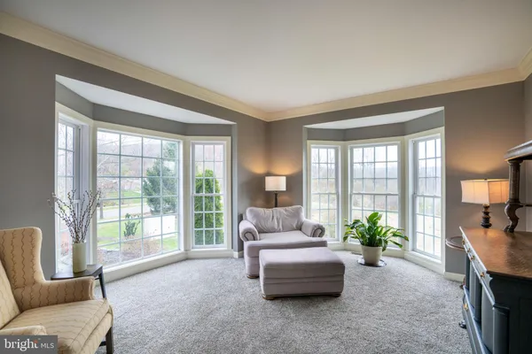 a living room with furniture a fireplace and a large window