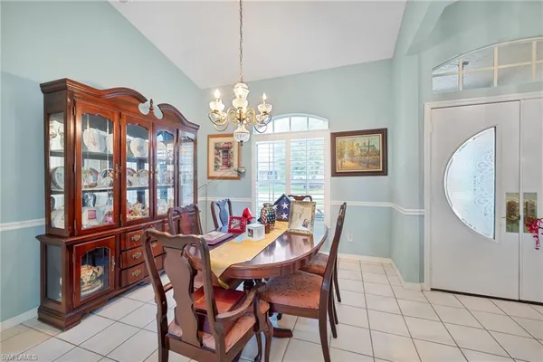 a view of a dining room with furniture and chandelier