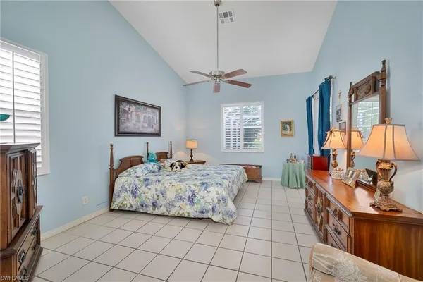 a bed room with a bed and a chandelier