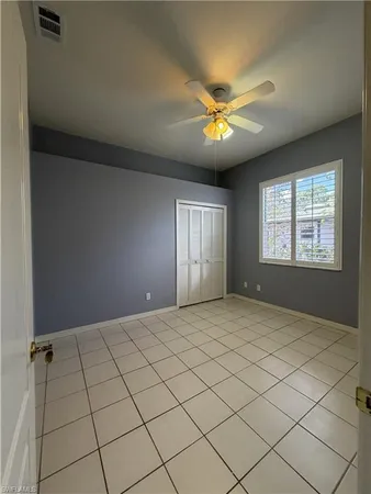 a bedroom with a bed dresser and window