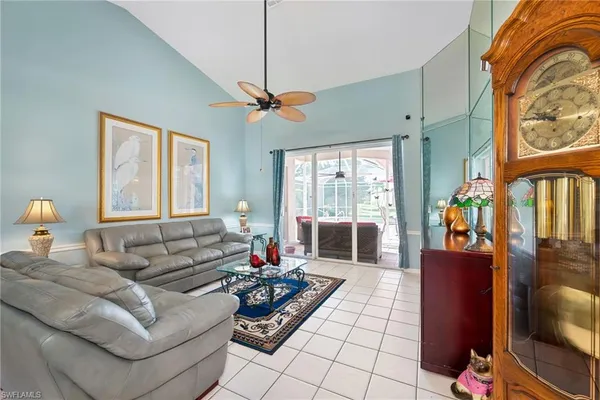 a living room with furniture and a chandelier