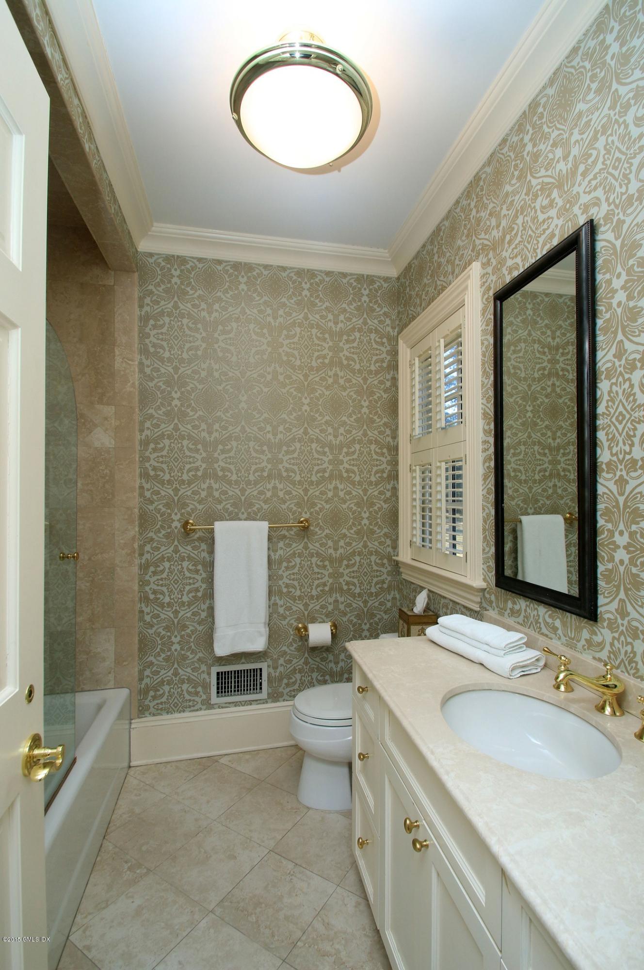 27 Chieftans Road Greenwich, CT 06831 - Photo 16 of 31 a bathroom with a double vanity sink toilet and mirror