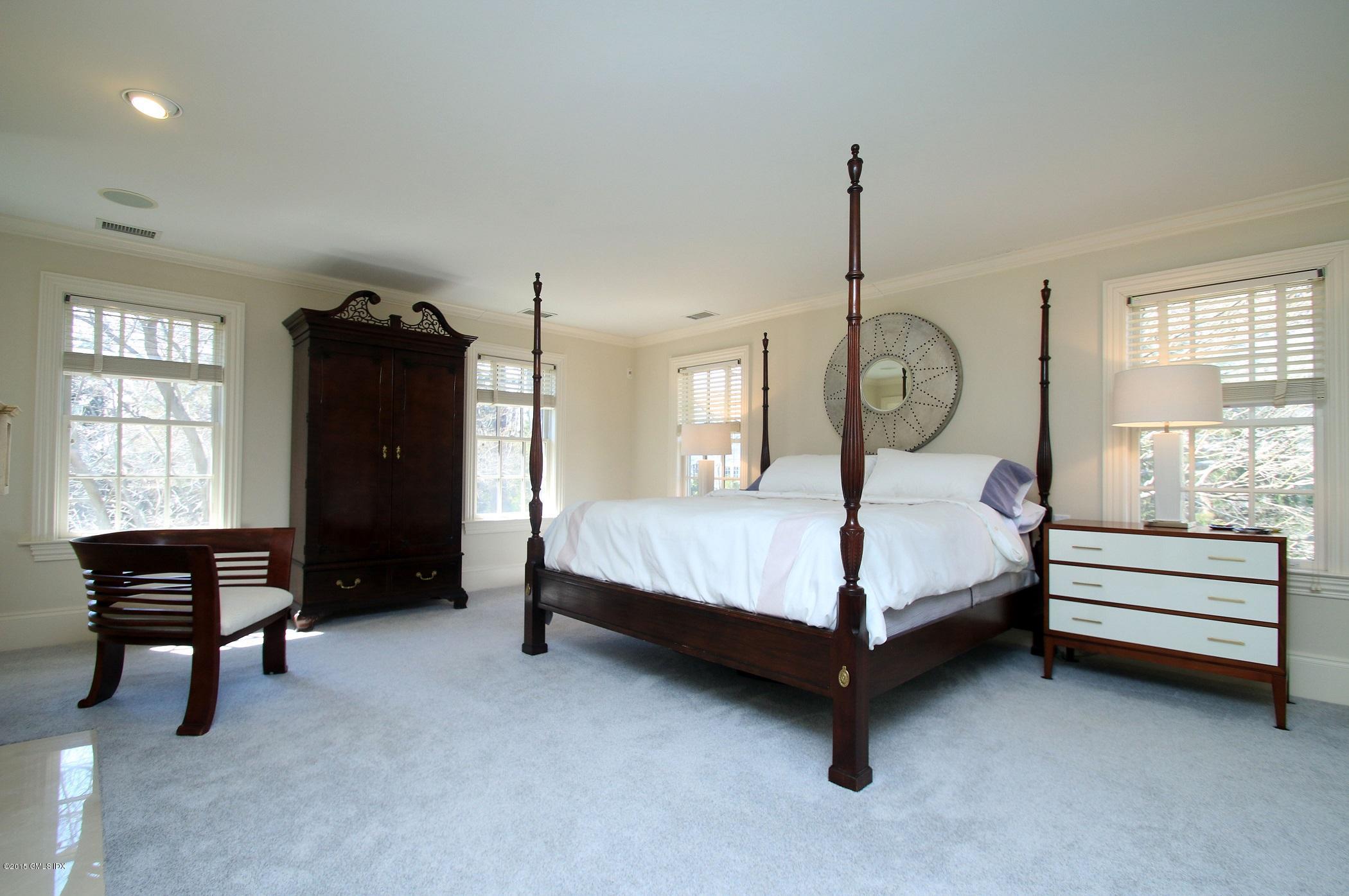 27 Chieftans Road Greenwich, CT 06831 - Photo 17 of 31 a bedroom with a bed and wooden floor