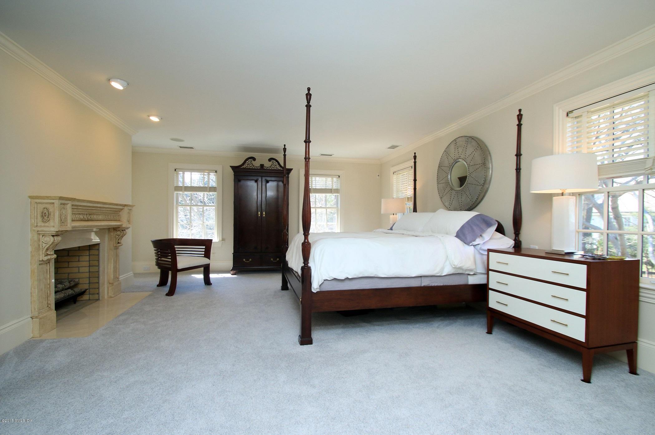 27 Chieftans Road Greenwich, CT 06831 - Photo 18 of 31 a bedroom with bed and a chandelier