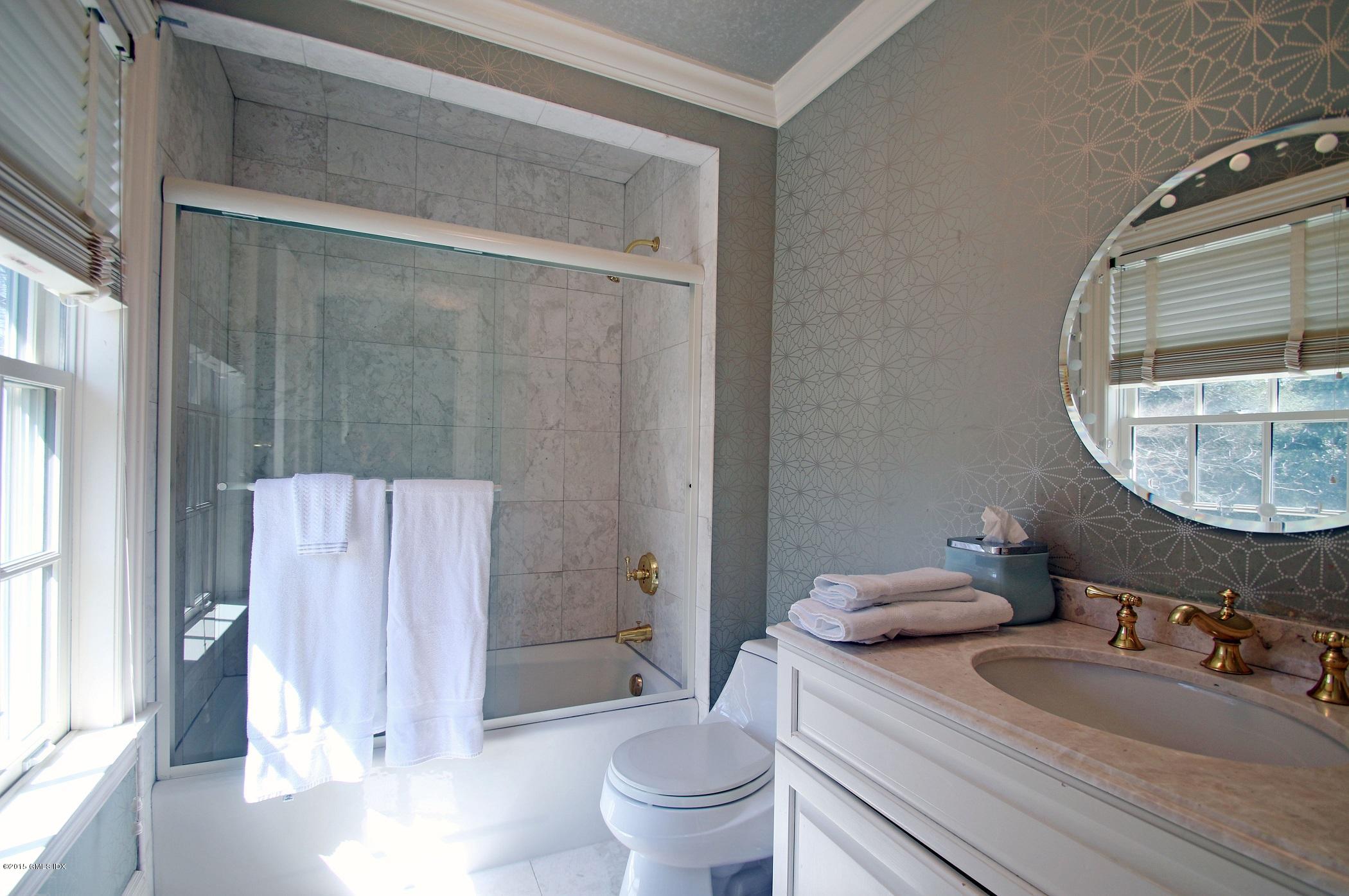 27 Chieftans Road Greenwich, CT 06831 - Photo 23 of 31 a bathroom with a sink and a mirror