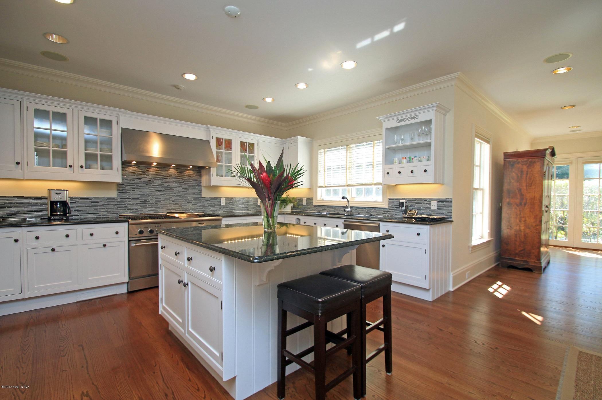 27 Chieftans Road Greenwich, CT 06831 - Photo 9 of 31 a kitchen with granite countertop a sink cabinets and wooden floor