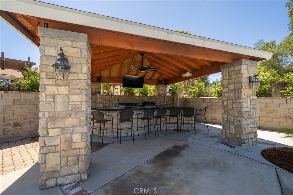 16639 Fox Glen Road Riverside, CA 92504 - Photo 99 of 153 a view of a patio with a table and chairs under an umbrella