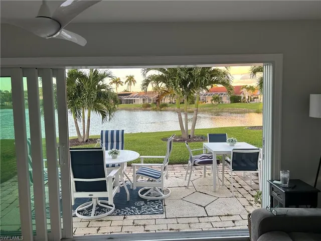 a living room with fireplace furniture and a floor to ceiling window