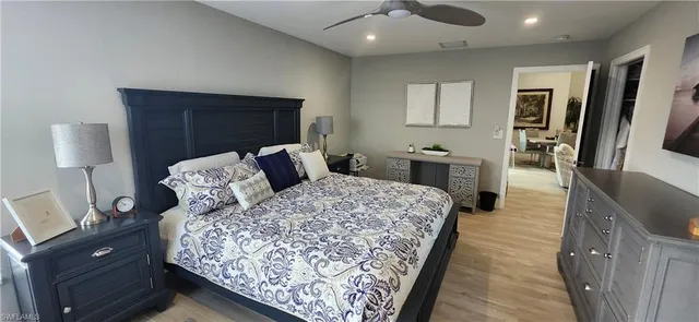 a bed room with a bed window and a mirror