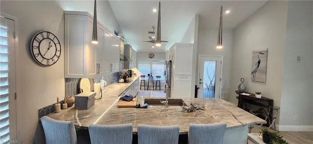 a view of a dining room with furniture and a chandelier