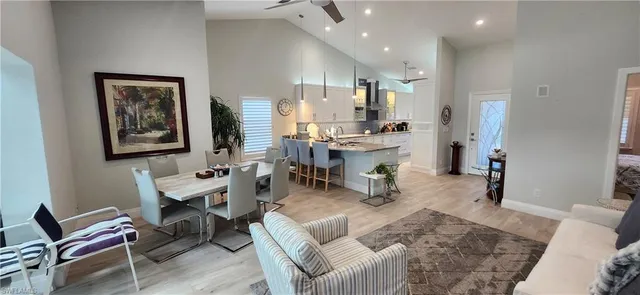 a living room with furniture a wooden floor and a chandelier
