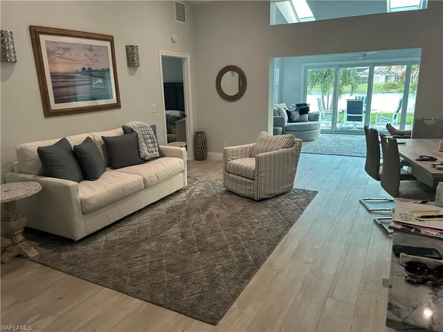 a living room with furniture wooden floor and window