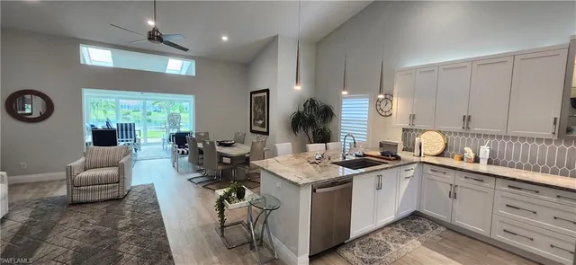 a kitchen with a sink appliances and cabinets