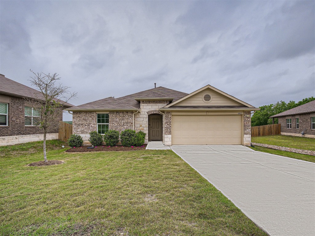 10912 Gonzales Ranger Pass Austin, TX 78754 - Photo 1 of 1 a front view of a house with a yard and garage