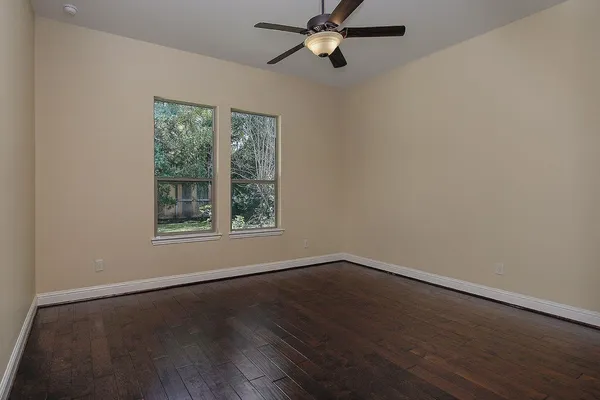 a view of a room with wooden floor and windows