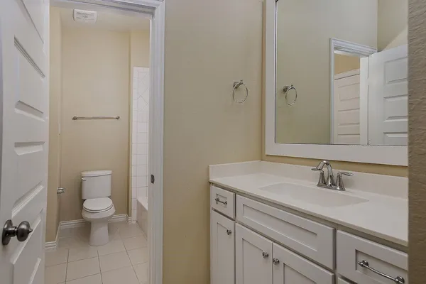 a view of bathroom with a sink toilet and a mirror