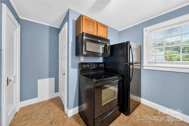 a kitchen with stainless steel appliances granite countertop a refrigerator stove and microwave
