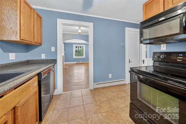 a kitchen with stainless steel appliances granite countertop a stove and a microwave