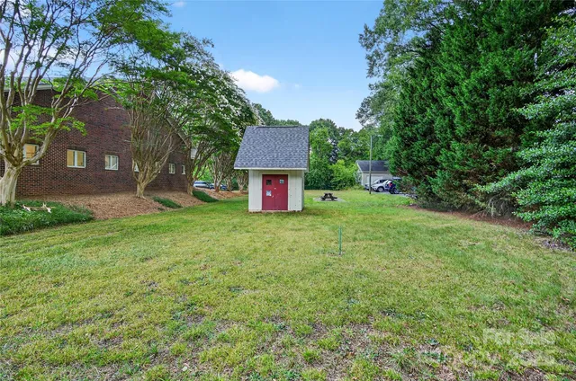 a view of a wooden house with a yard
