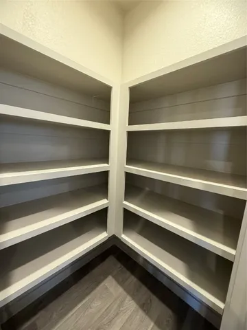 a view of room with wooden floor