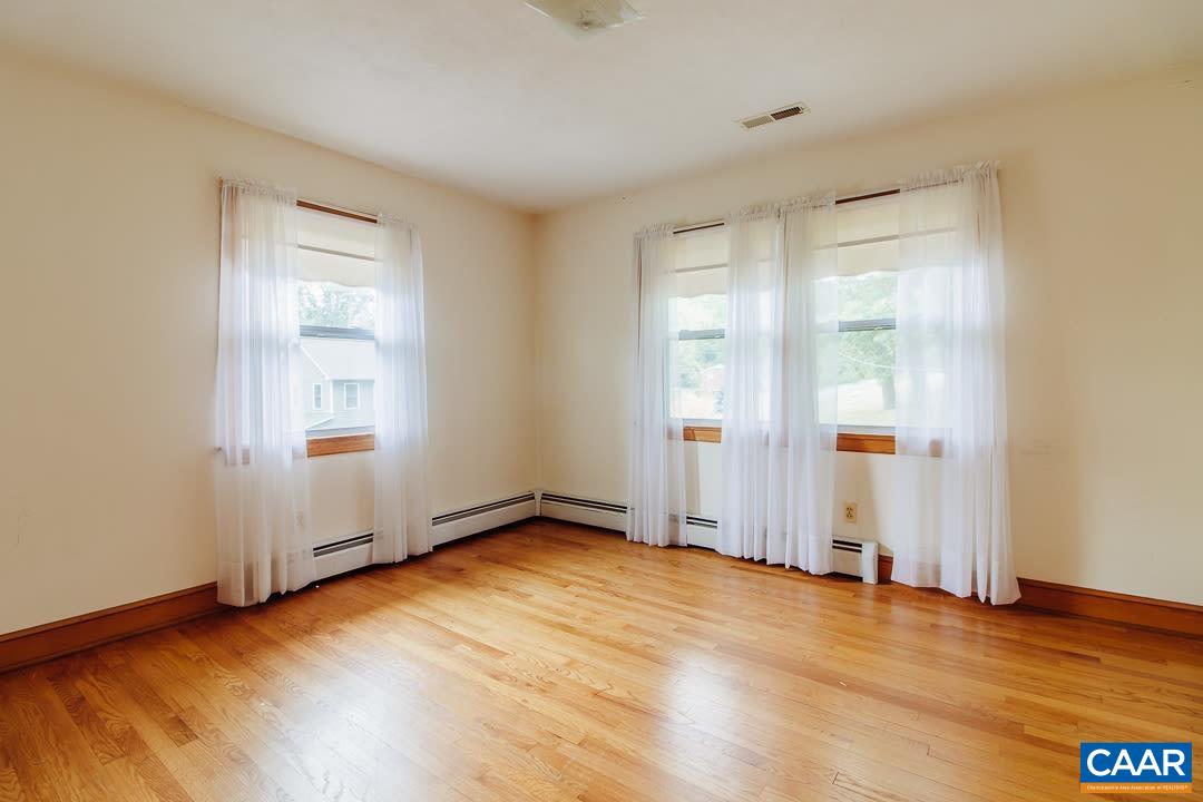 5742 Willow Spring Road Crozet, VA 22932 - Photo 14 of 34 an empty room with wooden floor and windows
