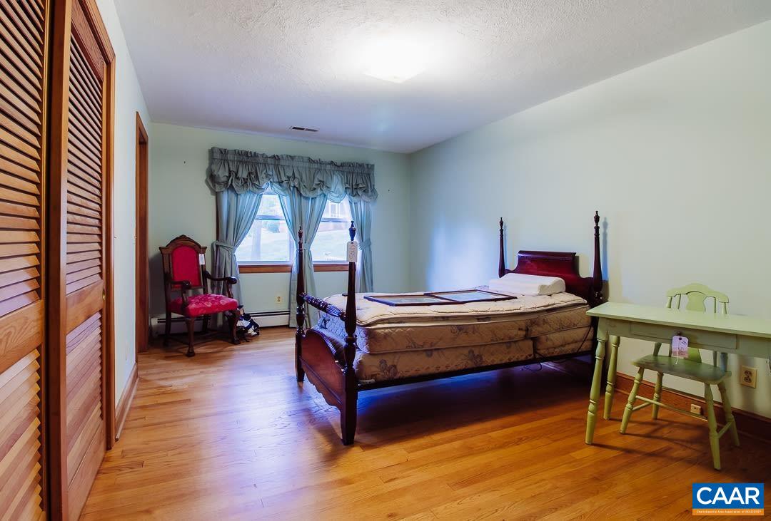 5742 Willow Spring Road Crozet, VA 22932 - Photo 20 of 34 a bed room with a bed and a window