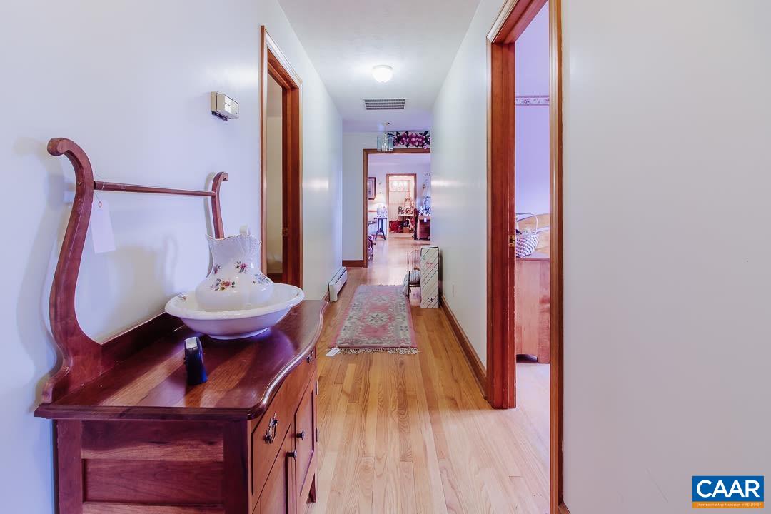 5742 Willow Spring Road Crozet, VA 22932 - Photo 22 of 34 a view of a hallway with furniture and wooden floor