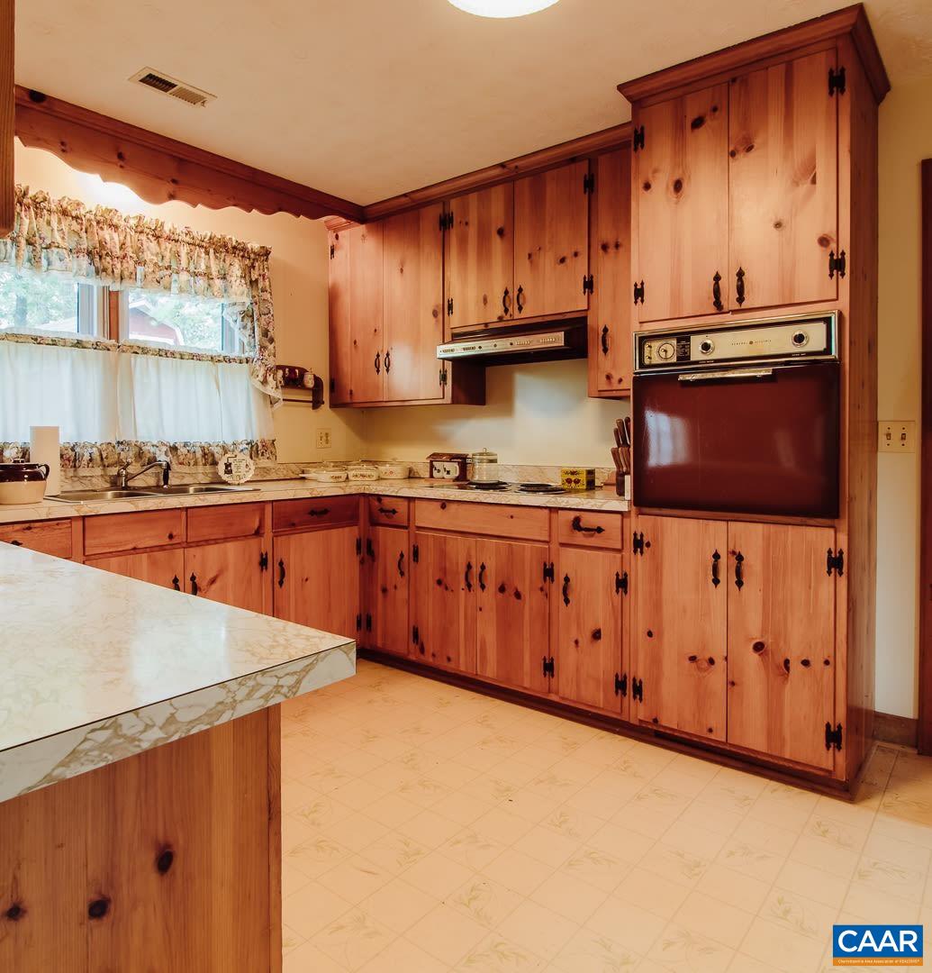 5742 Willow Spring Road Crozet, VA 22932 - Photo 10 of 34 a kitchen with stainless steel appliances a stove a sink and a microwave