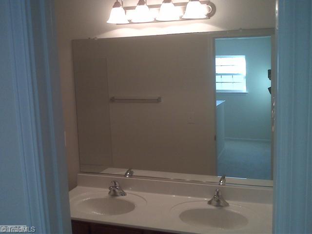 1328 Sharp Ridge Road Greensboro, NC 27406 - Photo 10 of 11 Other. Hall Bath upstairs with double sinks, hiden toilet and linen closet inside bathroom.