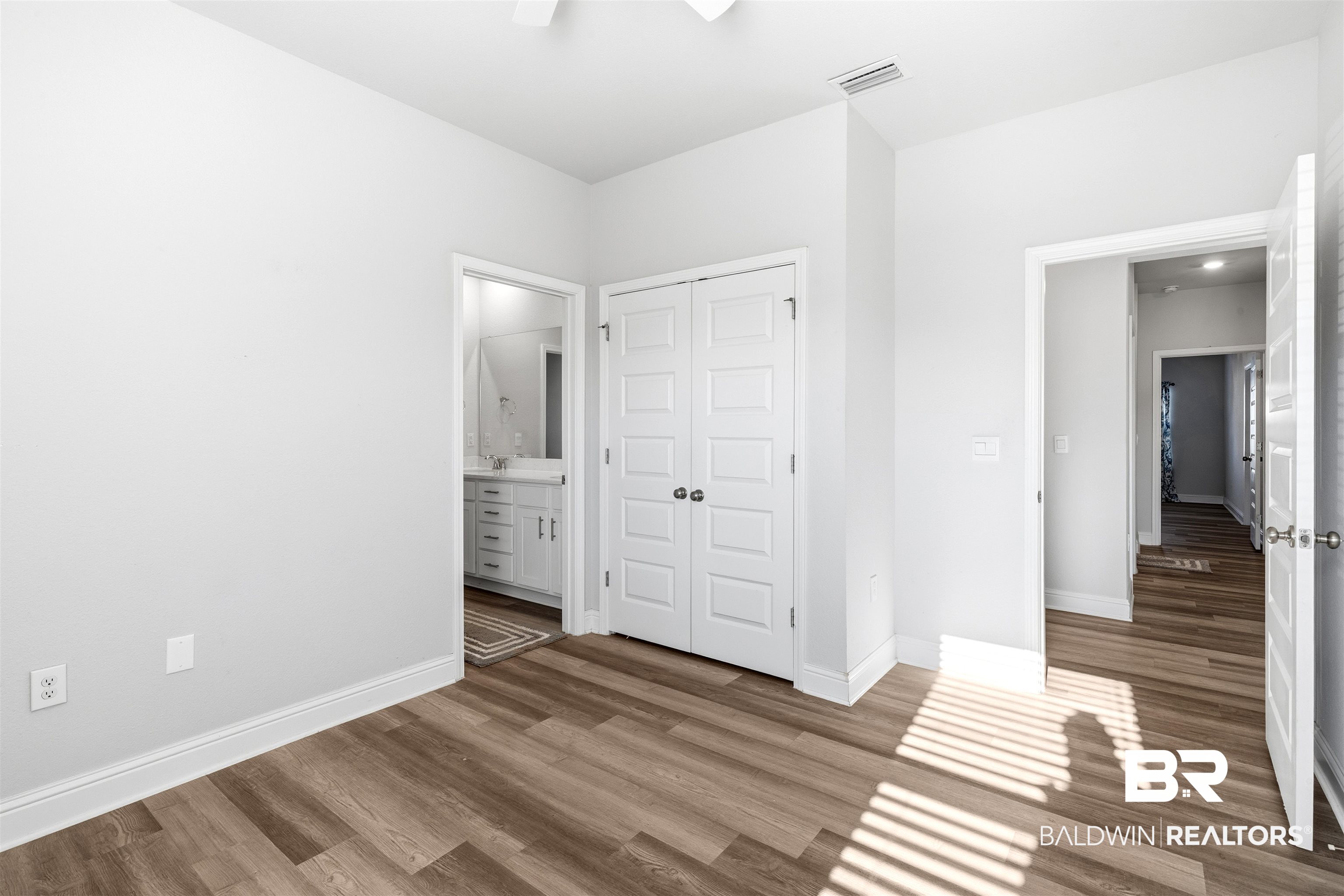 485 Shepard Street Gulf Shores, AL 36542 - Photo 37 of 53 Spare bedroom featuring ensuite bathroom, light wood-style flooring, a closet, and ceiling fan