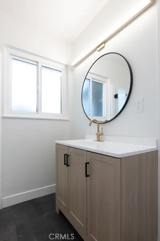 a bathroom with a sink a vanity and a mirror