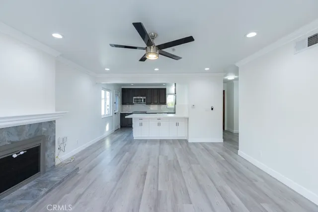 a living room with a fireplace and a ceiling fan