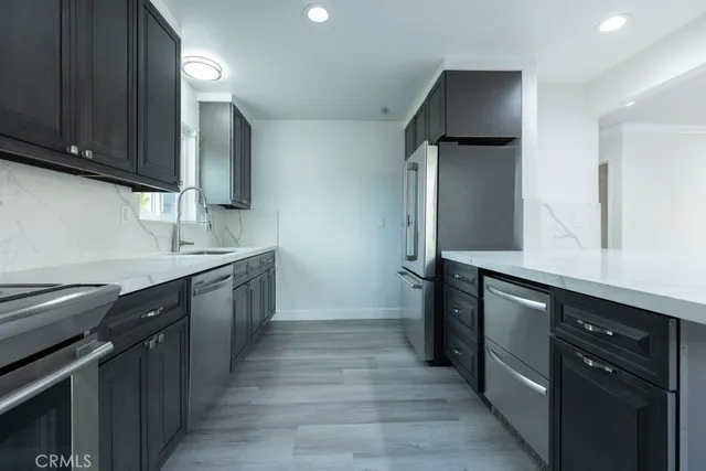 a kitchen with stainless steel appliances wooden cabinets and a sink