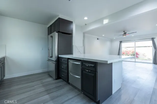 a kitchen with stainless steel appliances granite countertop a stove and a wooden floors