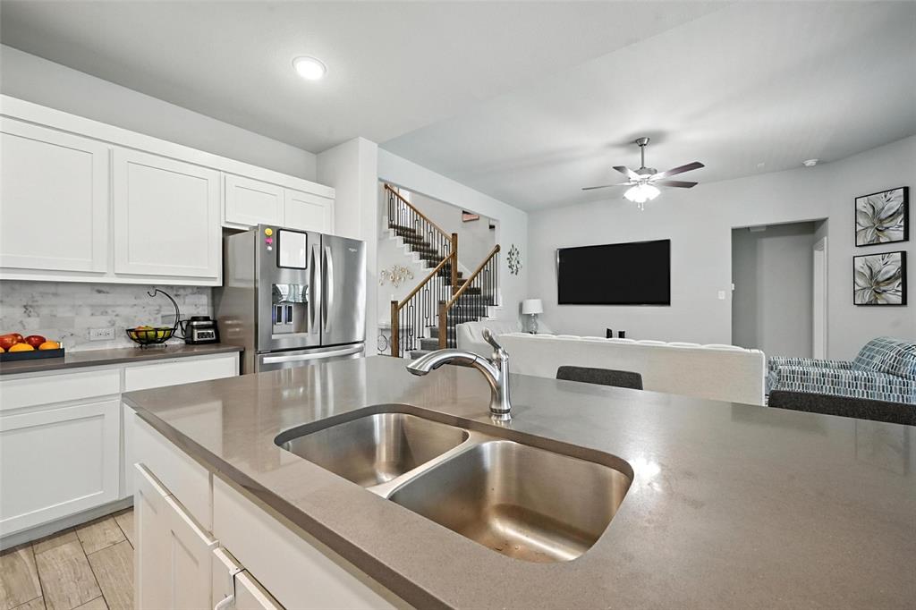 113 Nathan Drive Princeton, TX 75407 - Photo 14 of 39 a kitchen with stainless steel appliances a sink microwave and refrigerator