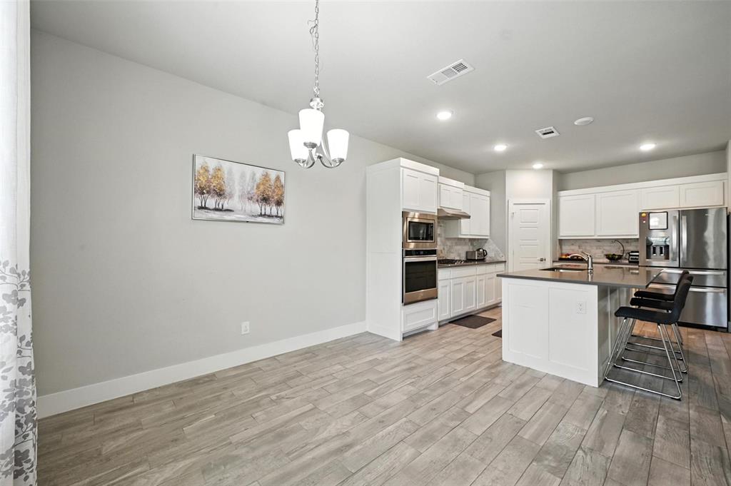 113 Nathan Drive Princeton, TX 75407 - Photo 17 of 39 a view of kitchen with refrigerator microwave and stove