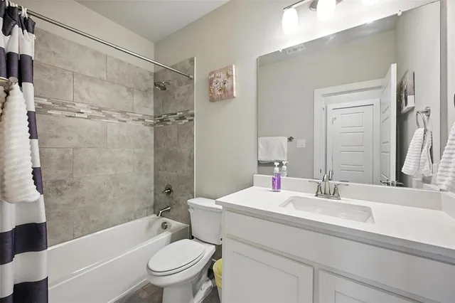 a view of a kitchen with kitchen island stainless steel appliances wooden floor cabinets and a potted plant