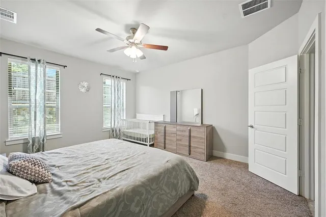 a bedroom with a bed and cabinets