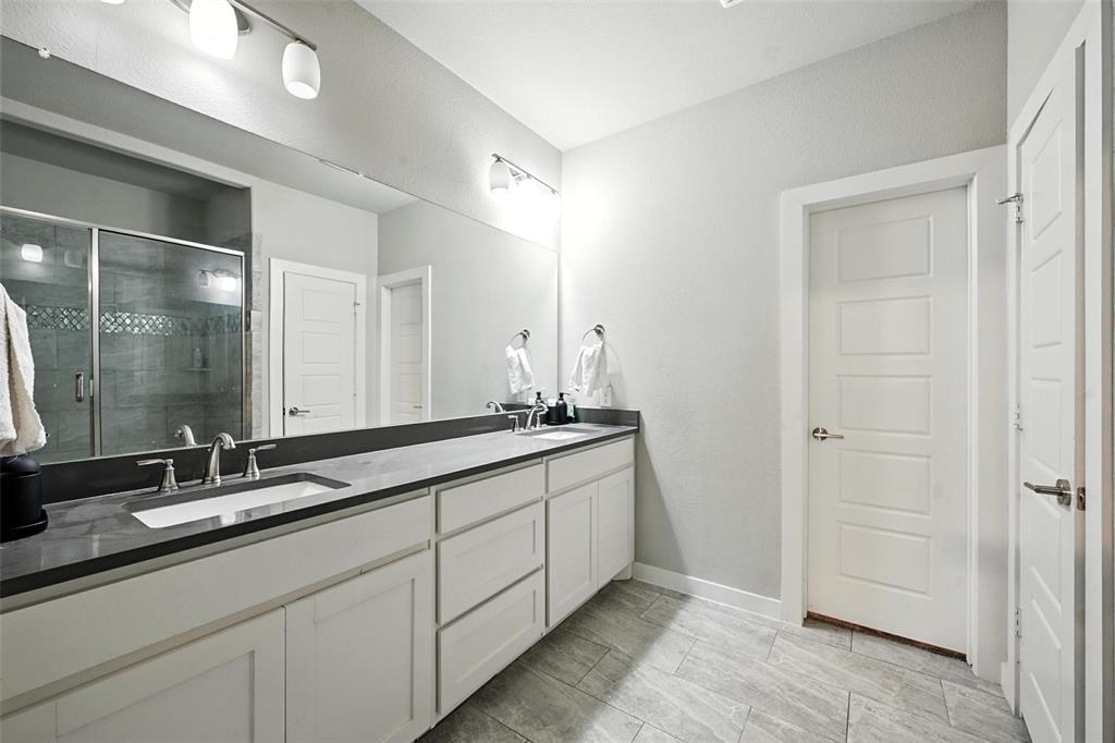 113 Nathan Drive Princeton, TX 75407 - Photo 23 of 39 a bathroom with double sink and a mirror