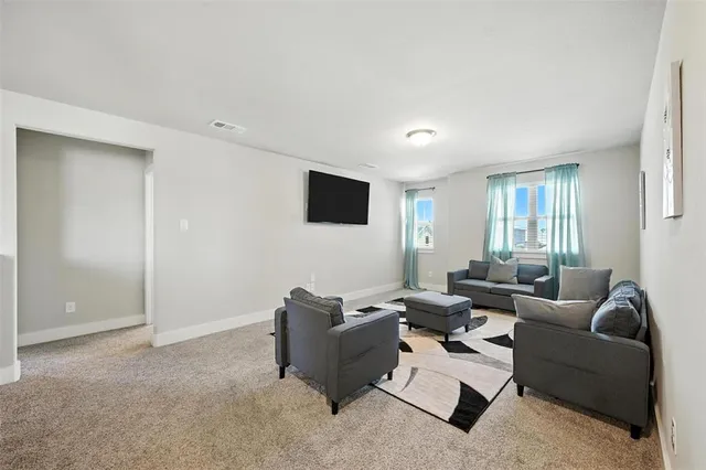 a view of walk in closet with clothes