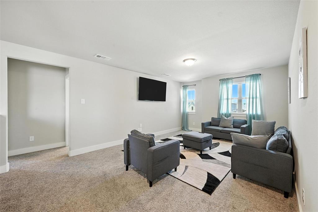 113 Nathan Drive Princeton, TX 75407 - Photo 26 of 39 a living room with furniture and a flat screen tv