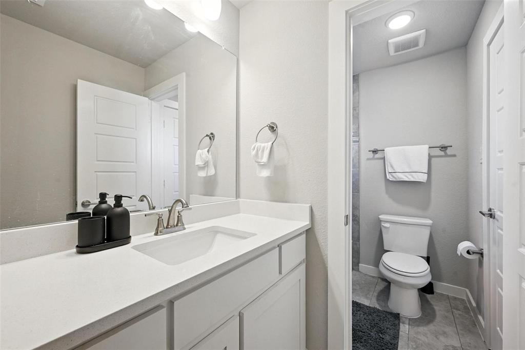 113 Nathan Drive Princeton, TX 75407 - Photo 28 of 39 a bathroom with a sink a toilet and a mirror